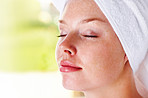 Closeup of a peaceful female with a towel wrapped on head