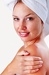 Smiling woman touching shoulder after a bath against white