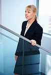 Woman walking up modern stairs