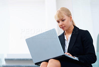 Buy stock photo Woman on steps in office with laptop, reading email or relax in lobby for market research on website. Professional businesswoman on stairs typing online review, feedback report or business schedule.