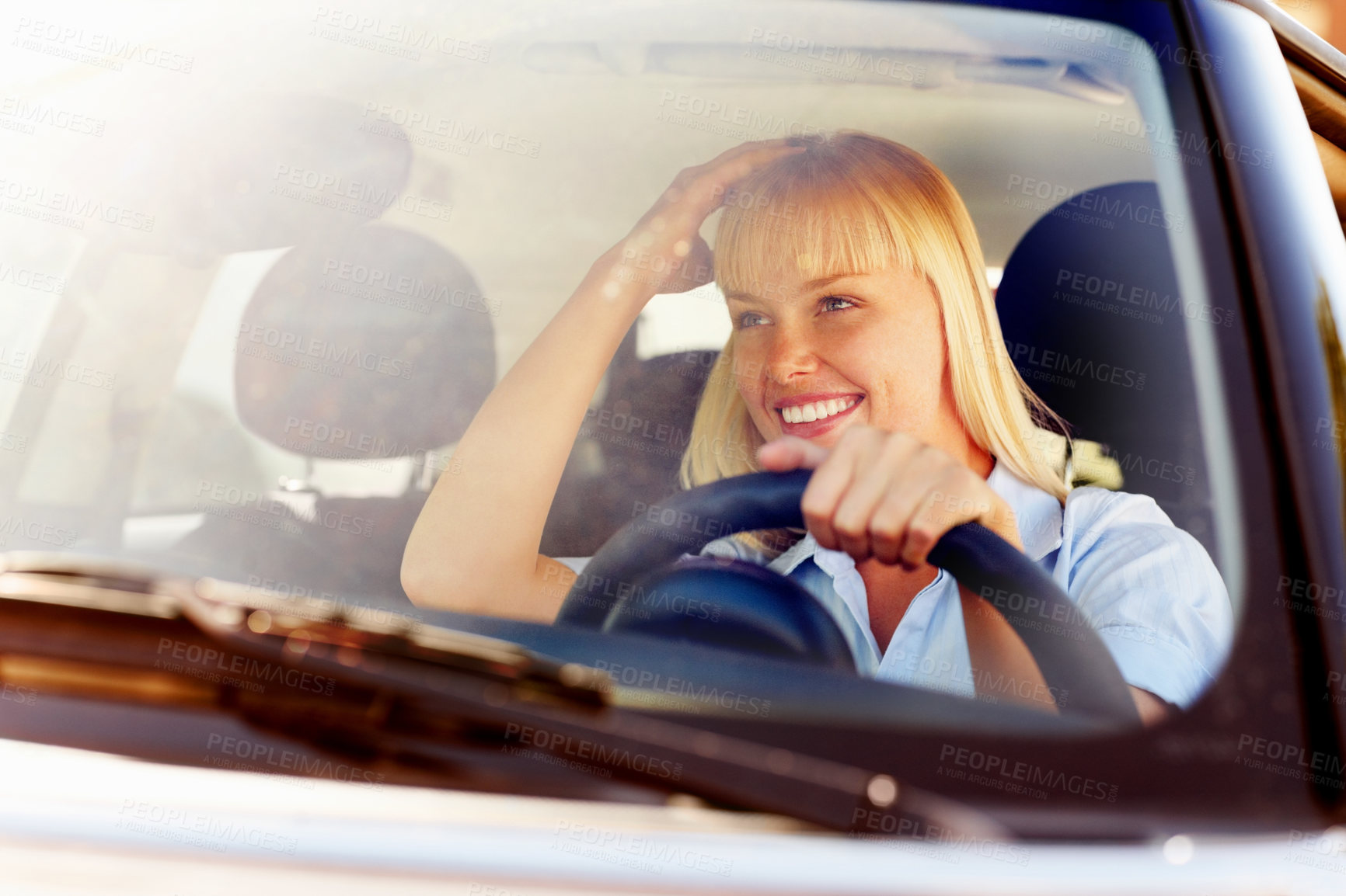 Buy stock photo Driver, woman and happy in car windscreen on mirror for travel or tour in summer, road trip and relax with adventure. Female person, vehicle and smile on journey for holiday or vacation in lens flare