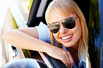 Happy modern woman sitting at the window of a car