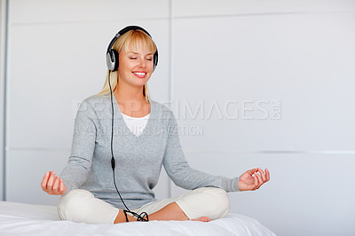 Buy stock photo Full length of young woman in lotus position enjoying music