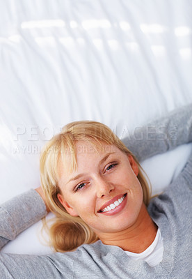 Buy stock photo Top view of pretty young woman lying on bed and smiling