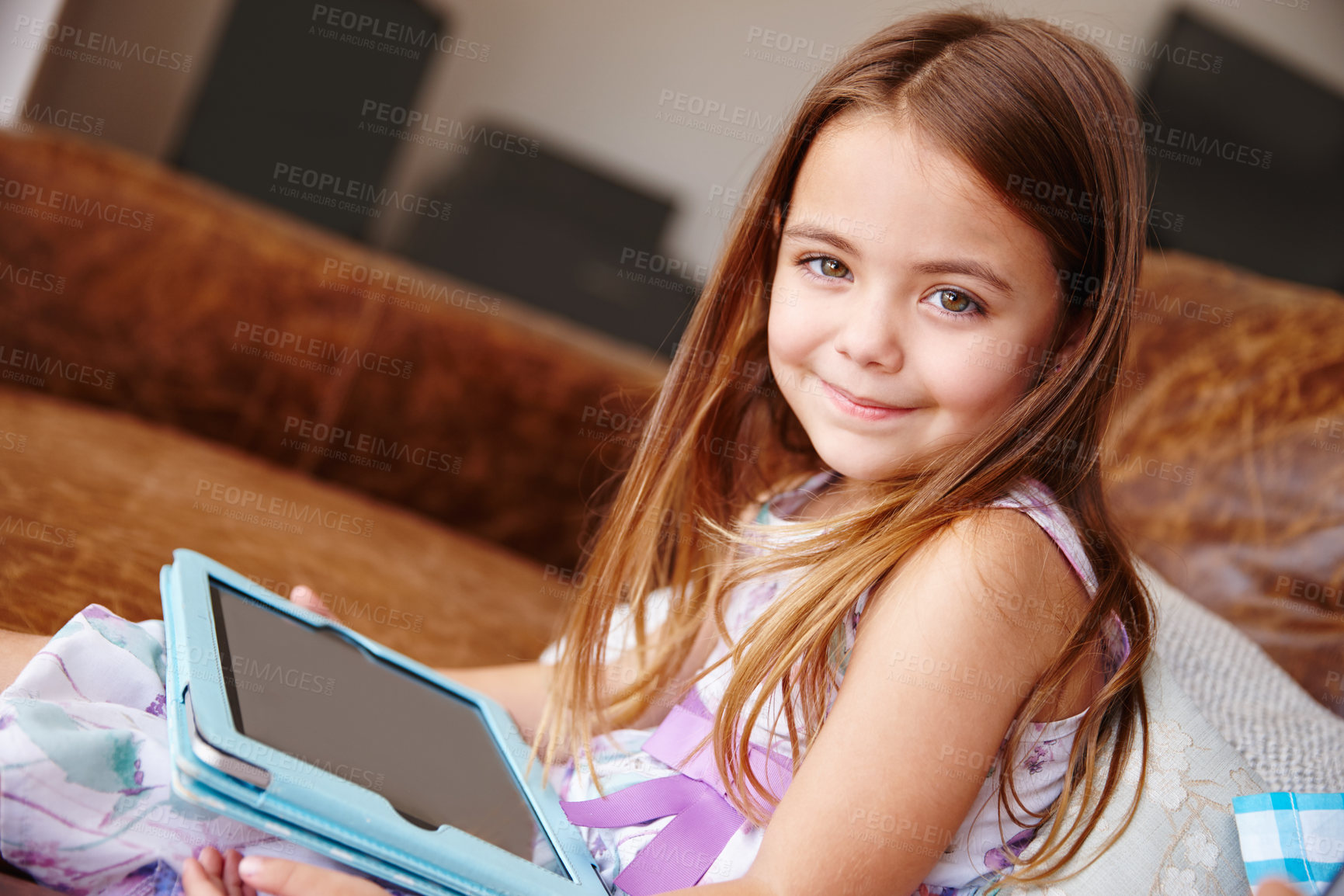 Buy stock photo Shot of a little girl using a digital tablet at home