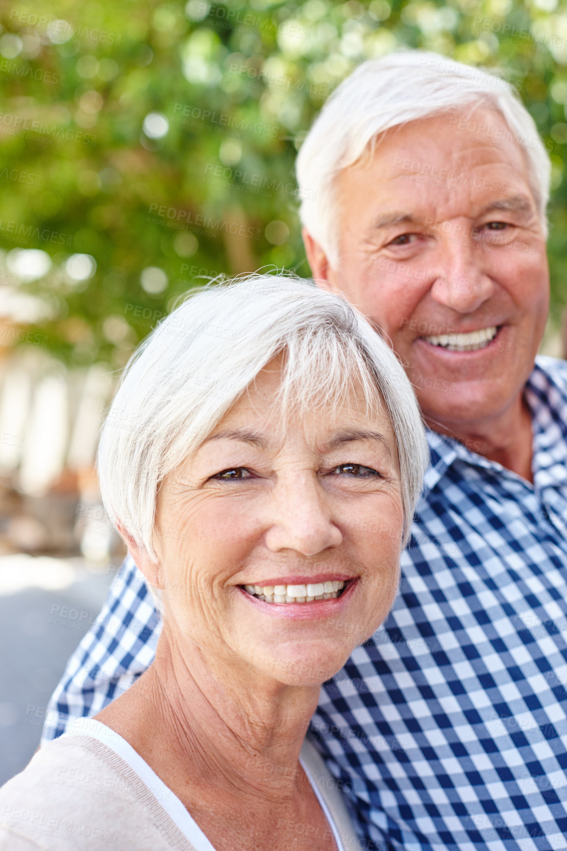 Buy stock photo Shot of a happy senior couple standing together outside