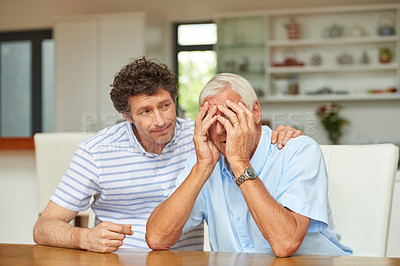Buy stock photo Shot of a man consoling his senior father at home