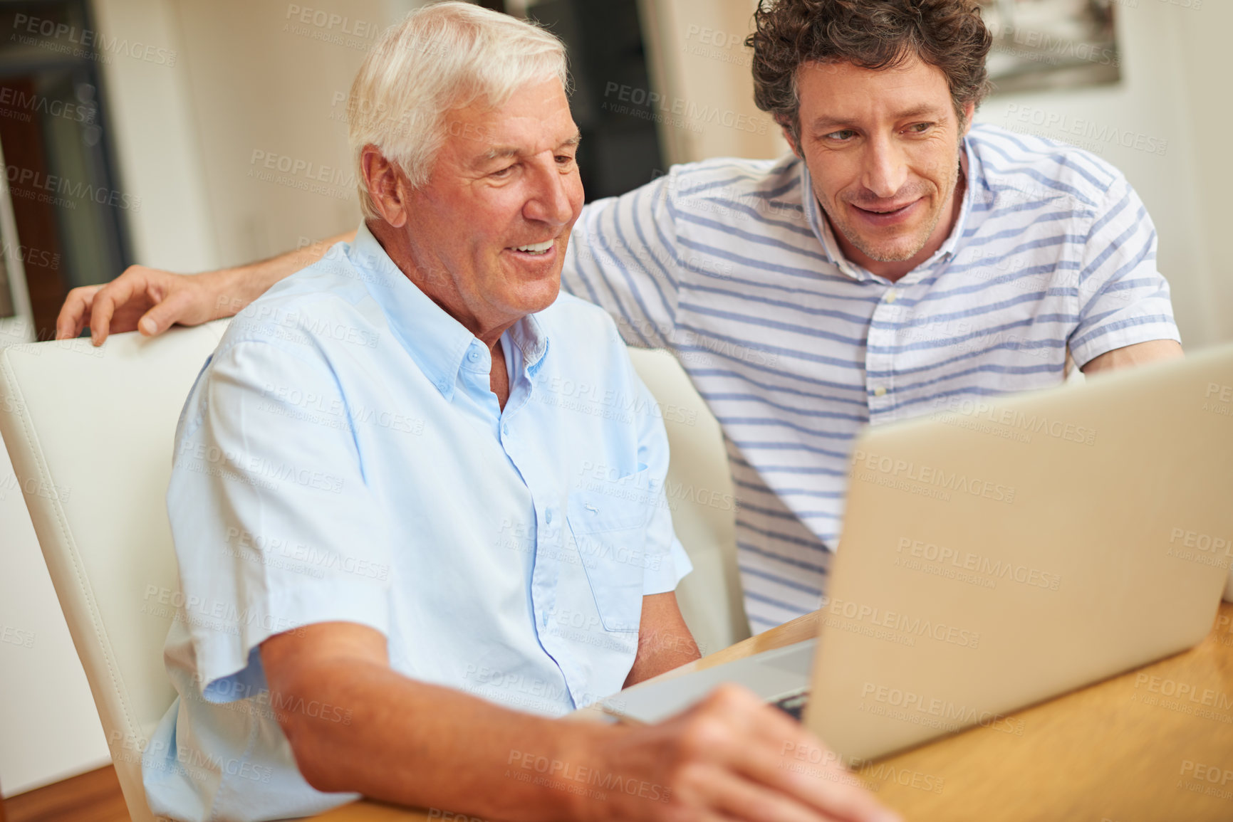 Buy stock photo Shot of a man and his father using a laptop indoors
