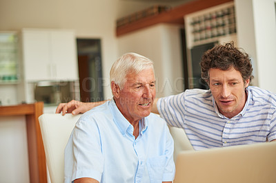Buy stock photo Shot of a man and his father using a laptop indoors