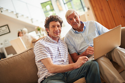 Buy stock photo Shot of a man and his father sitting with a laptop indoors