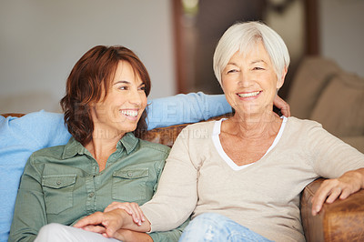 Buy stock photo Shot of a young woman and her mother sitting together indoors