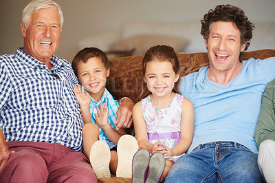 Buy stock photo Shot of two children sitting with their father and grandfather indoors