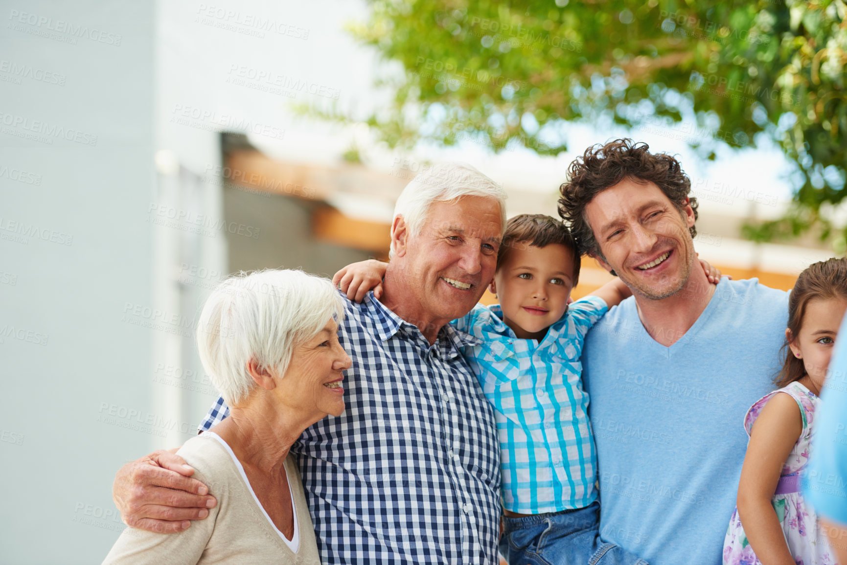 Buy stock photo Shot of a happy multi-generational family standing together outside