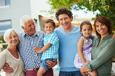 Buy stock photo Shot of a happy multi-generational family standing together outside