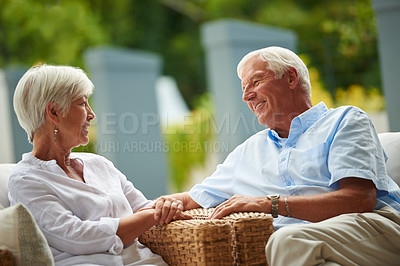 Buy stock photo Shot of a senior couple having a conversation on their patio
