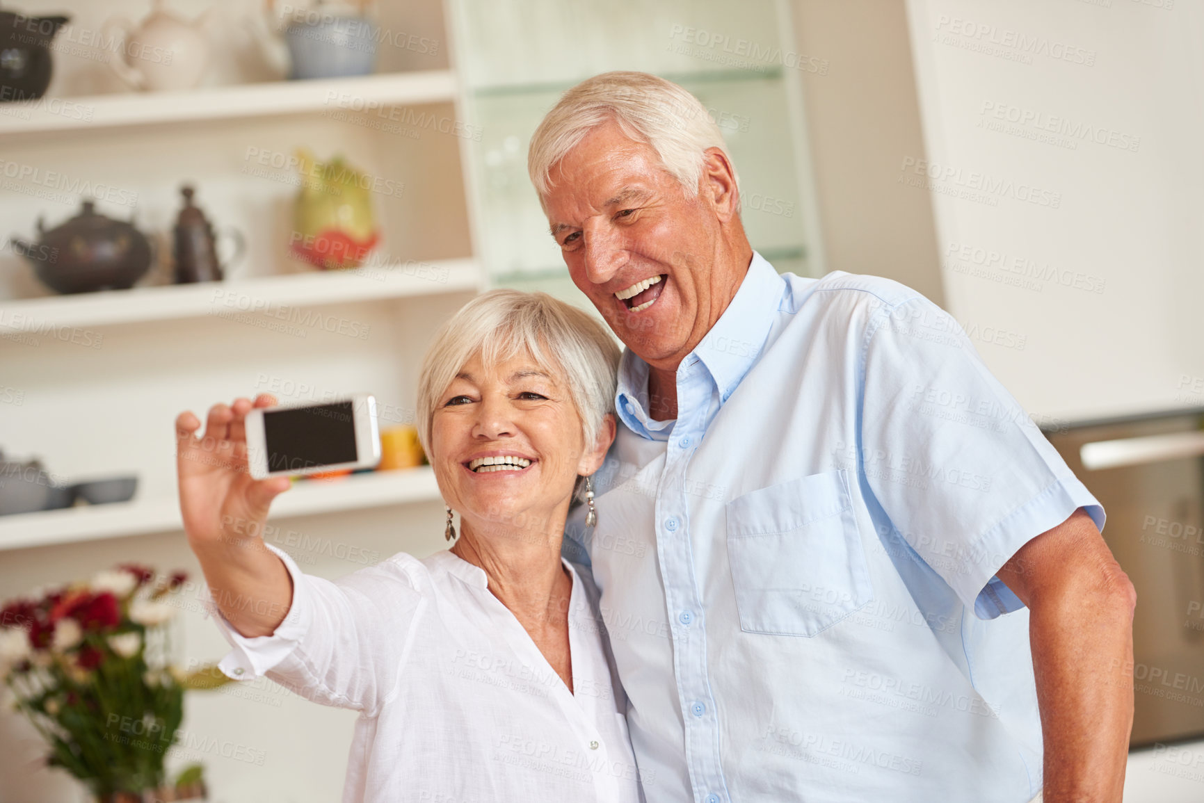 Buy stock photo Shot of a senior couple taking a selfie with their cellphone