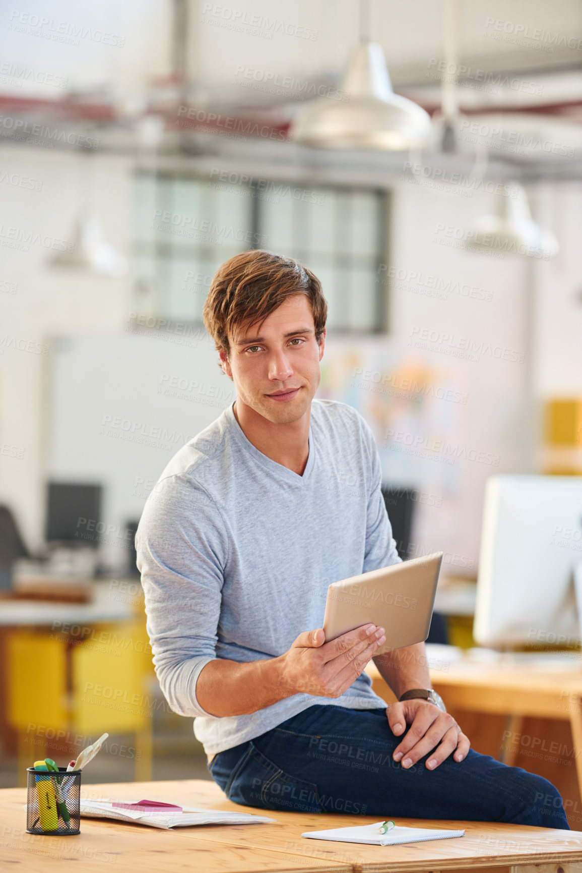 Buy stock photo Shot of a designer using a digital tablet while working in an office