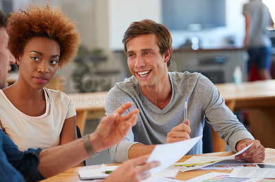 Buy stock photo Shot of a group of colleagues collaborating with each other on a project in an office