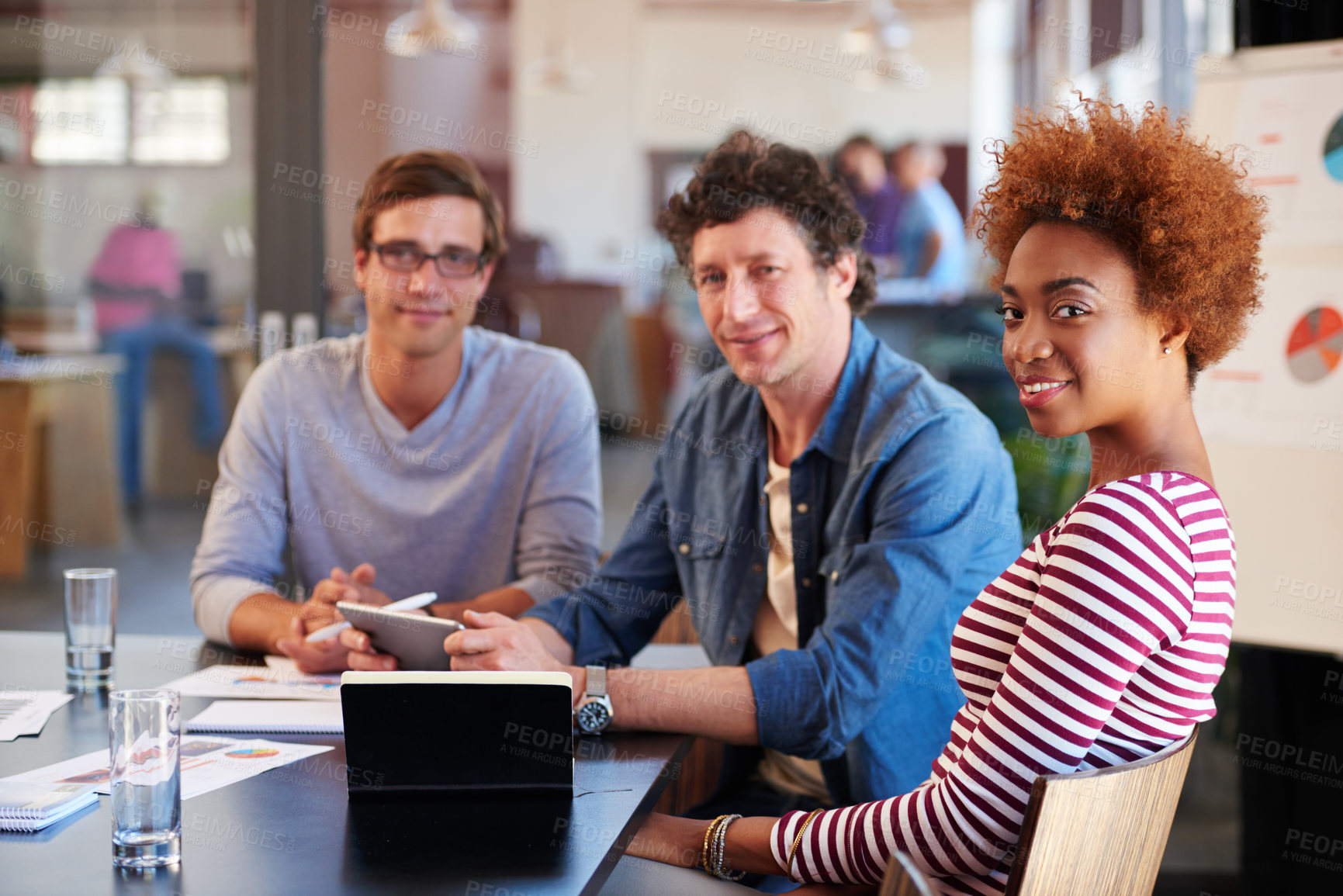 Buy stock photo Shot of a group of colleagues collaborating with each other on a project in an office