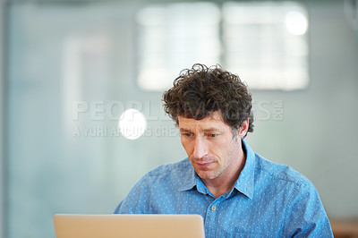 Buy stock photo Cropped shot of a handsome businessman working in the office