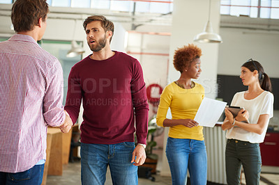 Buy stock photo Shot of a businesspeople shaking hands in an office