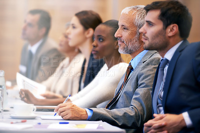 Buy stock photo Shot of a group of people sitting in a conference