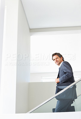 Buy stock photo Portrait of attractive mature executive walking down the stairs with bags