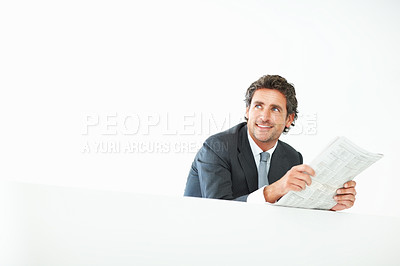 Buy stock photo Smiling business man leaning on the wall and reading newspaper