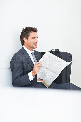 Buy stock photo Businessman, newspaper and reading at airport, article and lobby for flight departure or travel. Male person, work trip and information on print or story update, employee and suitcase for journey