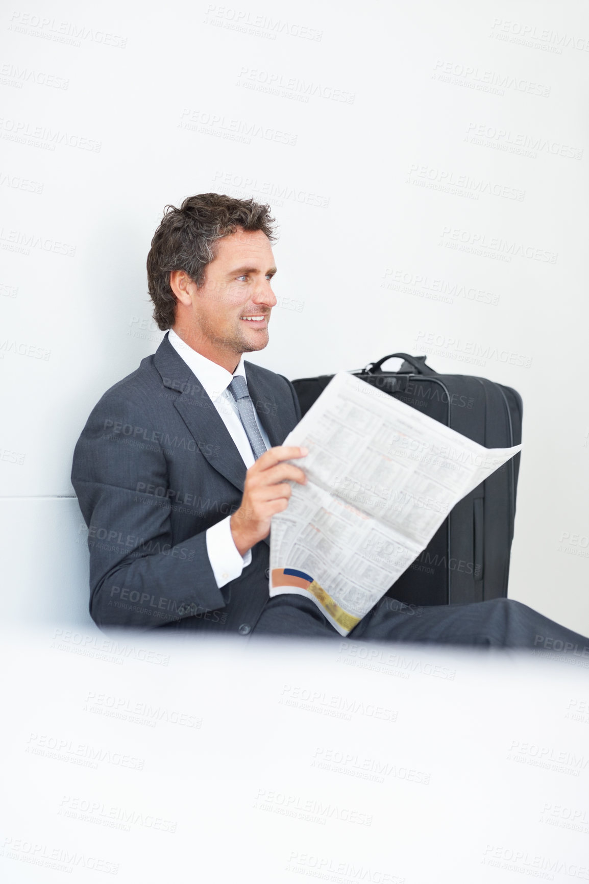 Buy stock photo Businessman, newspaper and reading at airport, article and lobby for flight departure or travel. Male person, work trip and information on print or story update, employee and suitcase for journey