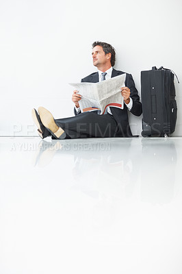 Buy stock photo Business man, newspaper and thinking at airport, article and lobby for flight departure or travel. Male person, work trip and information on print or story update, employee and suitcase for journey