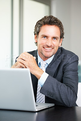 Buy stock photo Portrait of business man using laptop and giving you a warm smile