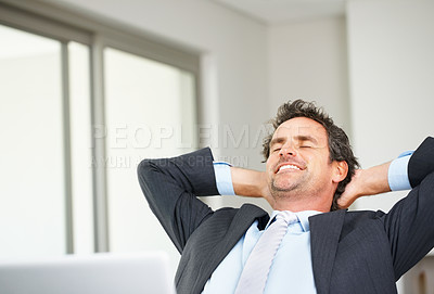 Buy stock photo Smart mature business man using laptop and relaxing with hands behind head