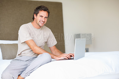 Buy stock photo Portrait, man in bedroom and laptop to work from home, typing and sitting in bed for freelance job. Technology, Entrepreneur and remote worker for online job, company and marketing projects
