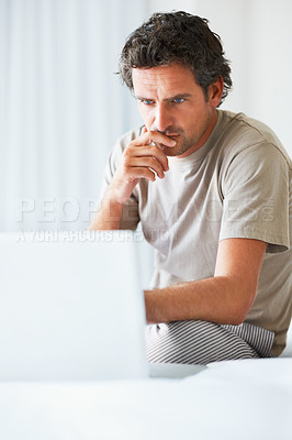 Buy stock photo Thinking, man in bedroom and laptop for work from home, serious and sitting in bed for freelance idea. Technology, entrepreneur and remote worker for online job, company and marketing projects
