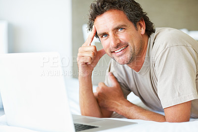 Buy stock photo Portrait, man in bedroom and laptop to work from home, happiness and sitting in bed for freelance job. Technology, Entrepreneur and remote worker for online job, company and marketing projects
