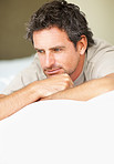Mature man relaxing on bed