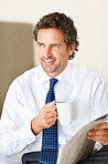 Business man with a cup of coffee and newspaper