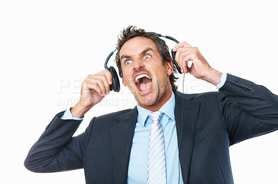 Buy stock photo Business man, headphones and scream to music, streaming radio and audio or song, mad on break. Male person, connection and shout to album, podcast and sound at studio, crazy and white background