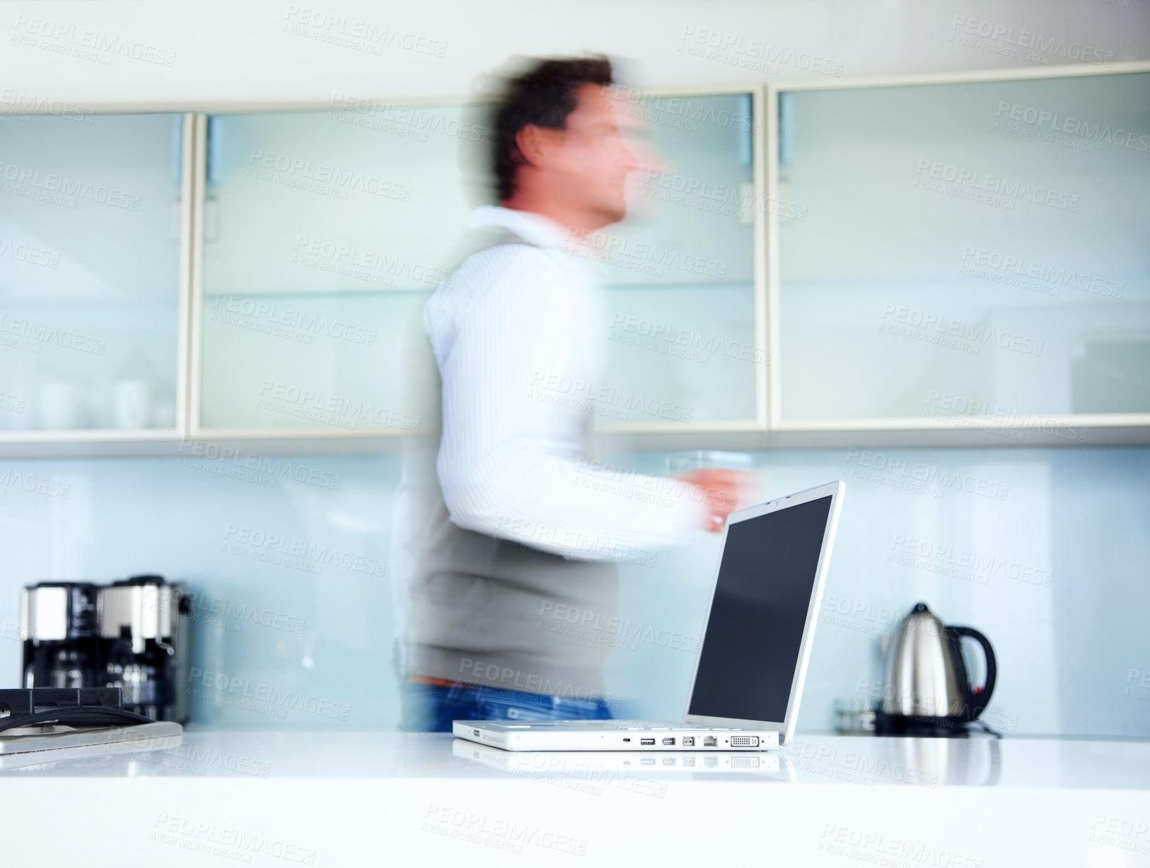 Buy stock photo Kitchen, blur and walking man with laptop, professional and speed with technology, creative agency and entrepreneur. Person, employee and graphic designer with computer, deadline and morning rush