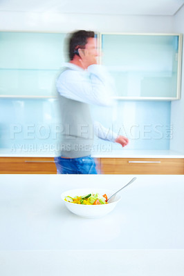 Buy stock photo Man, business and phone call with motion blur or talking in home kitchen with lunch salad, time management or late. Male person, cellphone and networking conversation with speed, crisis or nutrition