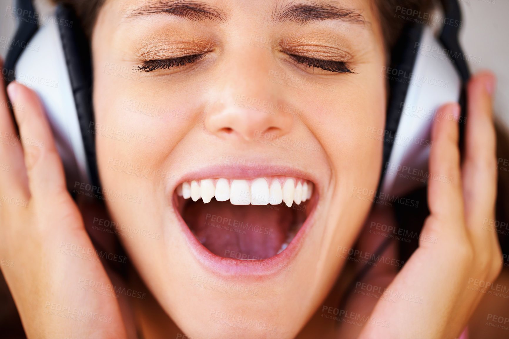 Buy stock photo Music, radio and podcast with a woman in headphones listening to and streaming audio while feeling excited, carefree and positive. Happy, freedom and shouting with the face of a young female closeup