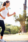 Healthy woman running on pathway