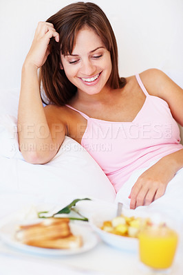 Buy stock photo Smile, relax and woman with breakfast in bed at hotel for pamper on vacation or holiday. Happy, food and female person resting with healthy meal and juice in morning in bedroom on weekend at home