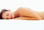 Bright image of a topless female fast asleep on the bed