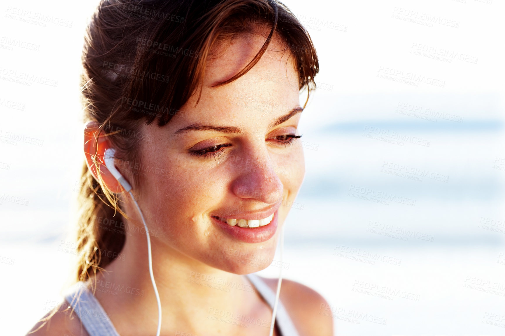 Buy stock photo Runner, thinking and woman on beach listening to music in headphones with sweat on face. Athlete, rest and streaming podcast to relax at ocean or happy break after running, training or fitness at sea