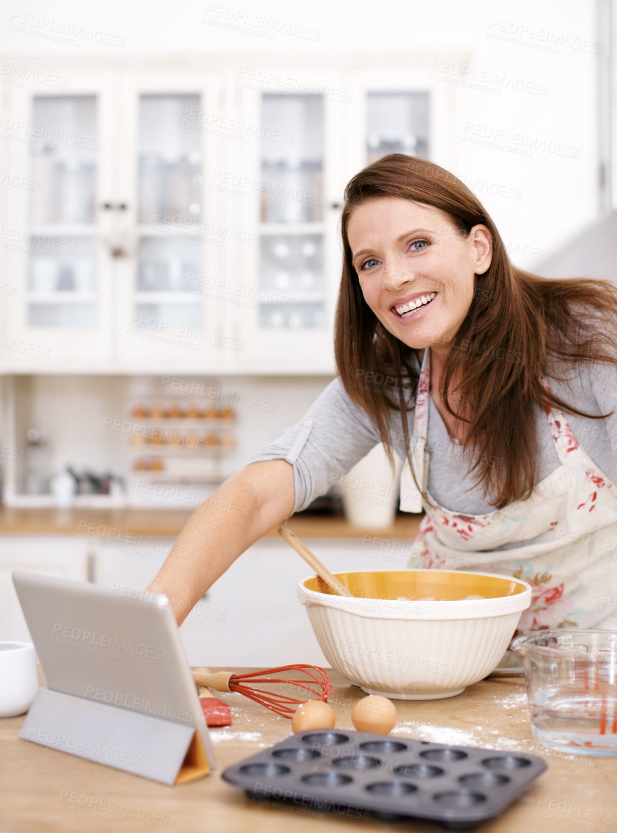 Buy stock photo Portrait, woman and baking with tablet at kitchen counter for ingredients, recipe or instruction on cake in home. Online, browsing internet and happy person with bowl for dessert, cookies or cupcakes