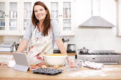 Buy stock photo Portrait of an attractive woman baking in the kitchen