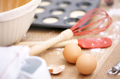 Buy stock photo Close up, bakery and eggs on table for cupcakes, breakfast and whisk on kitchen counter. Preparation, ingredients and food in cafe for baking, dessert and cake for small business and coffee shop