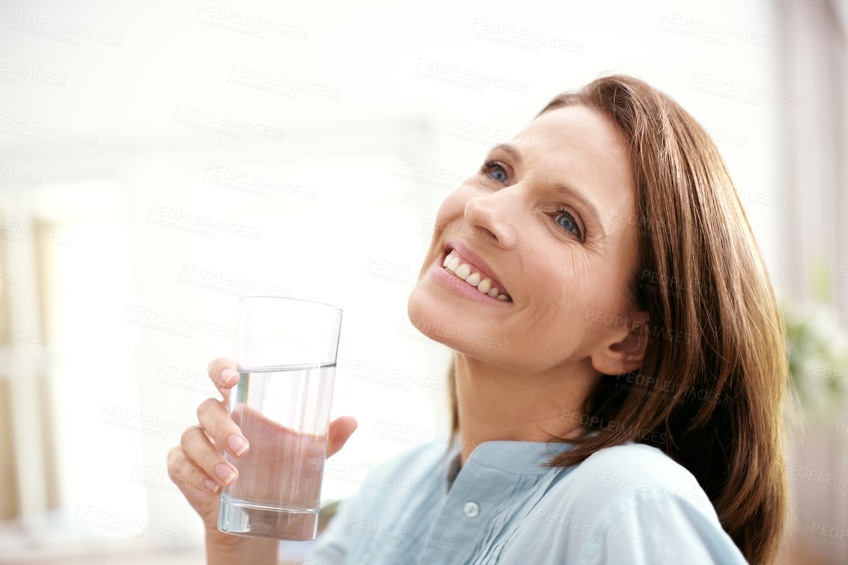 Buy stock photo Home, smile and woman with water in glass for hydration, healthy diet and liquid nutrition in morning. Mature person, thirsty and relax with aqua in house for h2o minerals, wellness and happiness